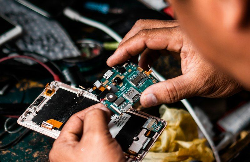 Technician repairing an Android smartphone