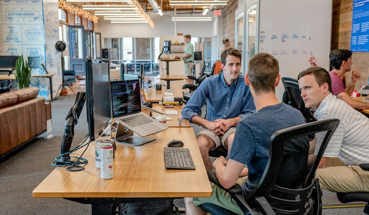 Business team meeting around laptops