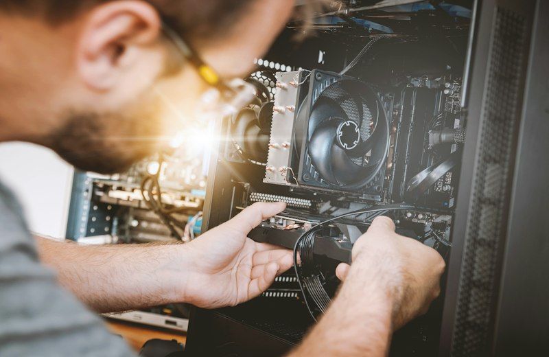 Technician installing hardware in a desktop PC